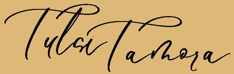 Logo for Tulsi Tamora in cursive font on a light brown background.